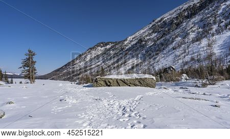 Mountains Against The Blue Sky. The Forest Grows On The Slopes. At The Foot There Are Picturesque Bo