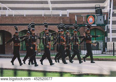 Wagah Border, Pakistan - July 22, 2021: Brave Pakistan Soldiers In Bright Military Uniform Marching 