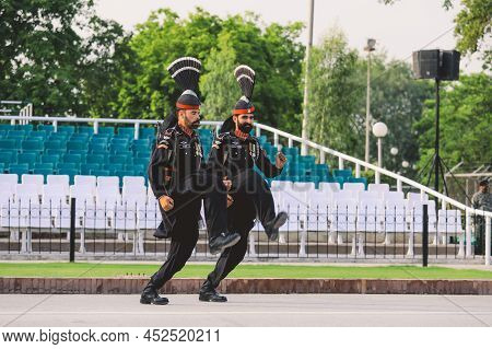Wagah Border, Pakistan - July 22, 2021: Brave Pakistan Soldiers In Bright Military Uniform Marching 