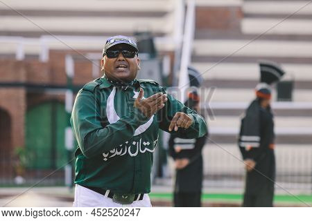 Wagah Border, Pakistan - July 22, 2021: Brave Pakistan Soldiers In Bright Military Uniform Marching 