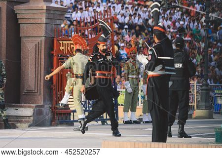 Wagah Border, Pakistan - July 22, 2021: Brave Pakistan Soldiers In Bright Military Uniform Marching 