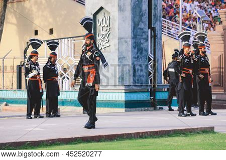 Wagah Border, Pakistan - July 22, 2021: Brave Pakistan Soldiers In Bright Military Uniform Marching 
