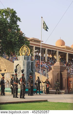Wagah Border, Pakistan - July 22, 2021: Brave Pakistan Soldiers In Bright Military Uniform Marching 