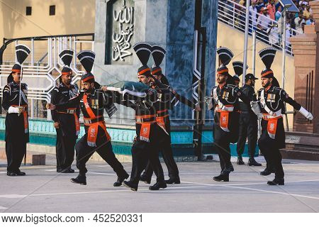 Wagah Border, Pakistan - July 22, 2021: Brave Pakistan Soldiers In Bright Military Uniform Marching 