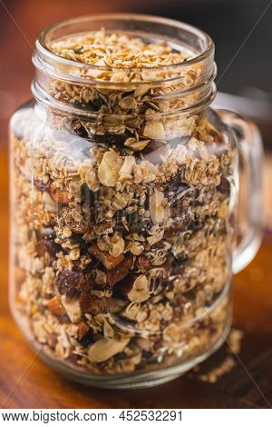 Granola Of Oatmeal, Pecans, Nuts, Oats, Dates, Pine Nut Spread From A Jar