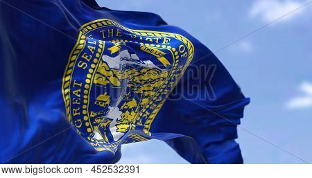 The Us State Flag Of Nebraska Waving In The Wind. Nebraska Is A State In The Midwestern Region Of Th