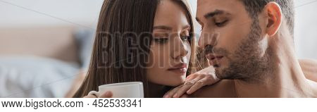 Pretty Woman Holding Coffee Near Shitless Man In Bedroom, Banner.