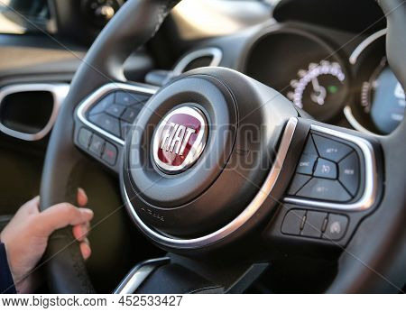 Italy - October 28, 2021: A Steering Wheel Of A Modern Fiat 500x Car With A Human Hand On It