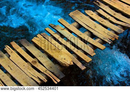 Old Wooden Bridge And A Flow River In Imlil