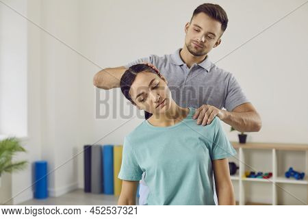 Chiropractor, Osteopath Or Manual Therapist Helping Young Patient Who Has Neck Pain