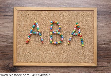 Applied Behavior Analysis Concept. Corkboard With Abbreviation Aba Made Of Colorful Pins On Wooden T