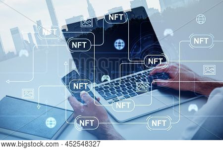Businessman Holding Smartphone Typing On Laptop. Digital Interface With Non-fungible Token Hologram 