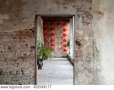 The Blur Concrete Entrance As Foregound, Chinese Lantern Hanging On The Wall.