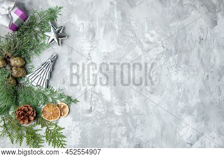 Top View Pine Tree Branches Lemon Slices Pinecones Xmas Tree Toys On Grey Background Copy Space