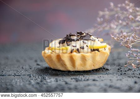 Front Close View Lemon Tart With Chocolate Dried Flower Branch On Dark Background With Free Space