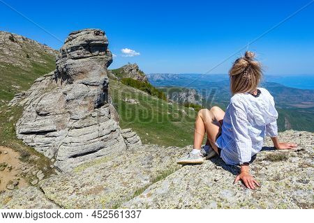 A Girl On The Background Of A View Of The Black Sea And The Stone Conglomerates Of The Demerdzhi Rid