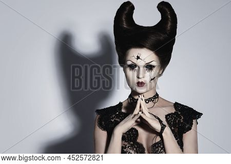 Spooky Porcelain Doll With Horns On Her Head.