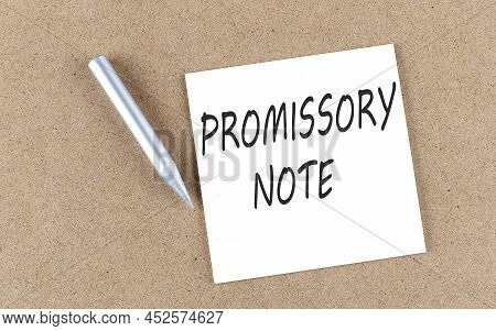 Promissory Note Text On A Sticky Note On A Cork Board With Pencil ,