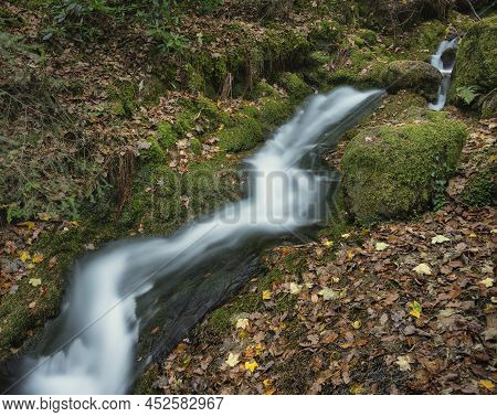Beautiful Waterfall Landscape Image In Vibrant Autumn Woodland In Lake District