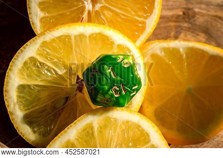 Image Of A Green D20 On Lemon Slices In The Sun