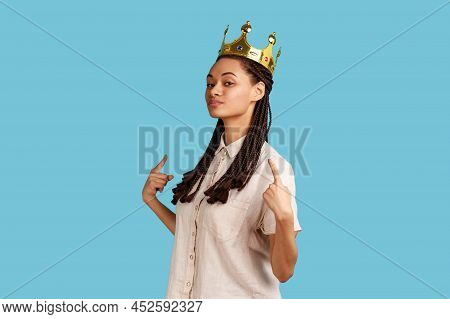 Portrait Of Proud Confident Arrogant Woman With Black Dreadlocks, Standing In Gold Crown, Pointing A