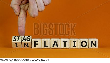 Stagflation Or Inflation Symbol. Businessman Turns Cubes And Changes The Concept Word Inflation To S