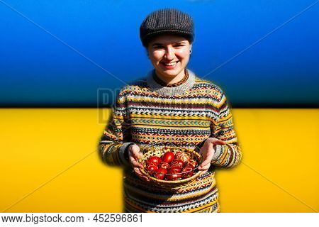 Defocus Ukrainian Young Smiling Woman In Hat Holding Plate Of Collection Of Red Egg On Nature Backgr