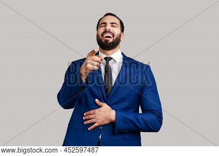 Positive Excited Bearded Man Laughing Out Loud Holding Belly And Pointing Finger On You, Mockery, We