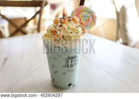 Blue Majik Smooothie With Whipping Cream And Candy Sugar On Wooden Table. Blue Milk.