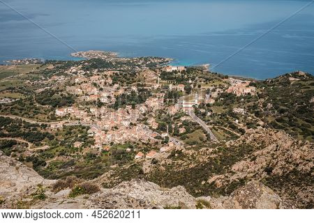 Hilltop Village Of Corbara In The Balagne Region Of Corsica With Mediterranean Sea In The Distance