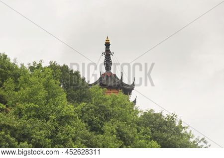 Cishou Pagoda Rising Above The Trees Within The Jinshan Buddhist Temple Scenic Area In Zhenjiang Chi