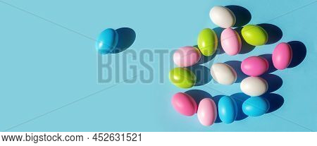 Multicolored Painted Easter Eggs On Blue Paper Background. Flat Lay  Top View With Copy Space. Banne