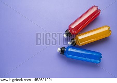 Isotonic Energy Drink. Bottle With Blue And Yellow Transparent Electolytes Liquid, Sport Beverage On