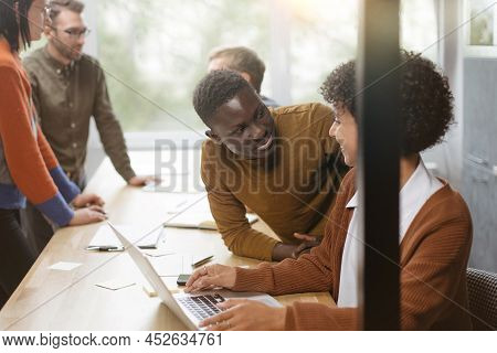 Businessman And A Group Of Employees Discussing Business Documen