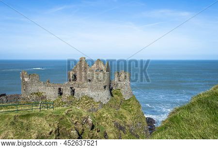 Bushmills, Northern Ireland, March 2022.. Dunluce Castle With Blue Sea Background In A Sunny Day.