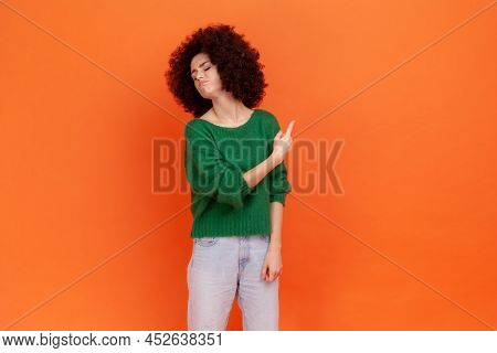 Get Out. Woman With Afro Hairstyle Wearing Green Casual Style Sweater Pointing Away, Scolding For Ba