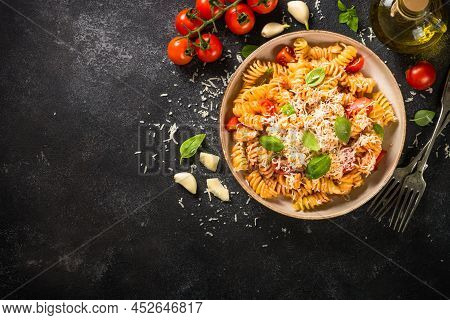 Italian Pasta Alla Arrabiata With Basil And Parmesan On Dark Table. Top View Image With Space For De