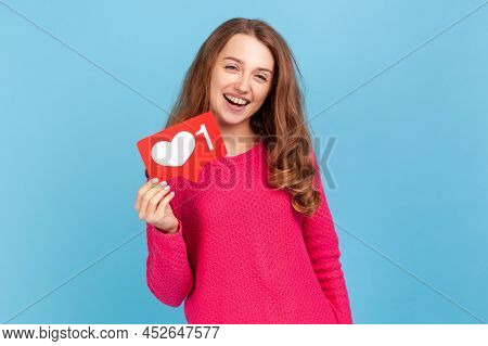 Love Interesting Content. Cheerful Carefree Woman Holding Heart Like Icon Of Social Media, Notificat