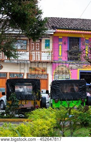Salento, Colombia - July 2021. Traditional Jeeps Willy Parked At The Main Square Of The Beautiful Sm