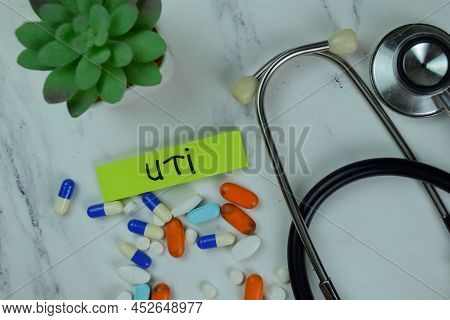 Uti Write On Sticky Notes Isolated On Wooden Table.