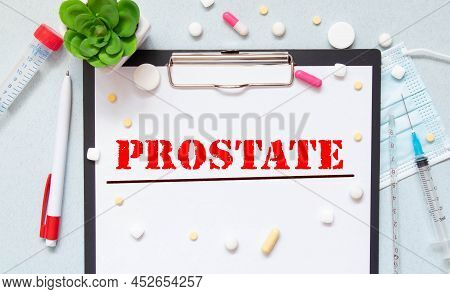 White Notepad With The Words Prostate Cancer And A Stethoscope On A Blue Backgroundd. Medical Concep