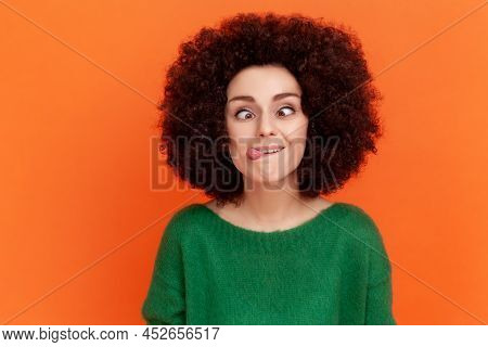 Foolish Woman With Afro Hairstyle Wearing Green Casual Style Sweater Standing With Crossed Eyes And 
