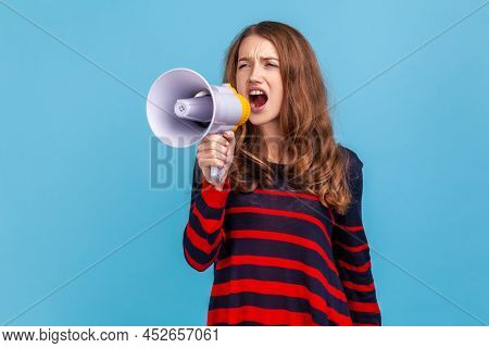 Portrait Of Woman Wearing Striped Casual Style Sweater, Screaming Loudly In Megaphone, Announcing Im
