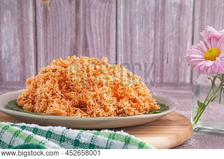 Sweet And Sour Crispy Noodles Or Mee Krob In The Thai Language On A Dish With Cloth, Vase, Cutlery P
