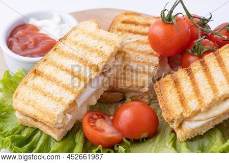 Tasty Club Sandwiches With Ham And Cheese On Wooden Table. Grilled And Pressed Toast With Smoked Ham
