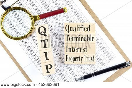 Qtip Qualified Terminable Interest Property Text On Wooden Block On A Chart Background