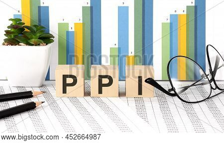 Ppi Word Written On Wood Block With Chart, Glasses And Pencils