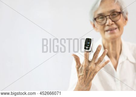 Hand Of Senior Woman With An Attached Pulse Oximeter On Fingertip,old Elderly Measuring Heart Rate,c