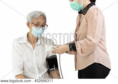 Female Caregiver Using Automatic Blood Pressure Monitor,checking Health,measuring Blood Pressure And