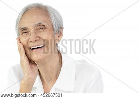 Asian Senior Woman With Beauty Face Touch Her Cheek,enjoy Healthy Facial Skin Feels Soft Smooth,anti